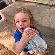 Mateo joined the competition — help win amazing prizes! child, toddler, water_bottle, blue_shirt, concrete, steps, outdoor, curly_hair, playful, rosy_cheeks, casual_clothing, daylight, childhood, cute, person, sitting, fun, drinking, closeup, natural_light