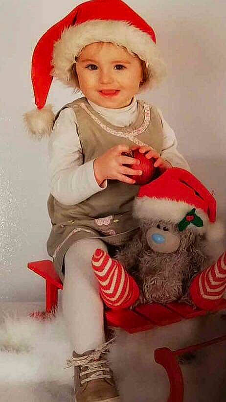 Celia participe au concours pour gagner de l'argent avec cette photo : child, christmas, christmas_ornament, costume, fictional_character, headwear, holiday, infant, joy, lap, person, product, santa_claus, toddler