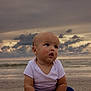baby, child, beach, ocean, sky, clouds, sand, sunset, sea, infant, portrait, curious, outdoor, nature, horizon, water, clothing, sitting, cute, young