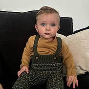 Atlas joined the competition — help win amazing prizes! toddler, child, baby, sitting, couch, clothing, knitwear, patterned_pants, suspenders, sweater, face, blue_eyes, hand, indoor, furniture, portrait, expression, fashion, cute, young_child