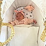Julia participe au concours pour gagner de l'argent avec cette photo : baby, newborn, sleeping, bassinet, blanket, pink_headband, pink_clothing, plush_toy, white_bassinet, cozy, infant, peaceful, soft, child, cute, indoors, portrait, resting, small_hands, head