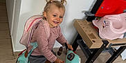 Valentine participe au concours pour gagner de l'argent avec cette photo : toddler, child, toy_scooter, pink_backpack, indoor, smiling, pigtails, playroom, toy_workbench, pink_potty_chair, floor, sneakers, happy, person, casual_clothing, wooden_floor, play, fun, young_child, cute