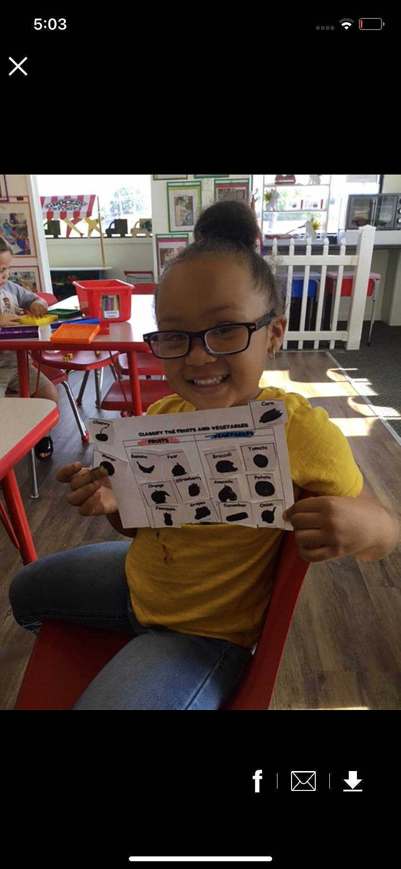 Legaci Caress is registered to the contest to win money with this photo: chair, child, comfort_food, eyewear, finger, fun, furniture, indoor_games_and_sports, joy, machine, person, personal_protective_equipment, recreation, room, sitting, sleeve, smile, t_shirt, table, tableware