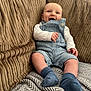 baby, smile, couch, blanket, overalls, socks, child, happy, indoor, portrait, clothing, furniture, texture, pattern, infant, person, relaxing, seated, cute, cozy
