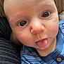 baby, close_up, face, tongue_out, blue_clothing, plaid, infant, cute, expression, skin, eyes, person, child, newborn, texture, soft_lighting, portrait, silly_face, head, young
