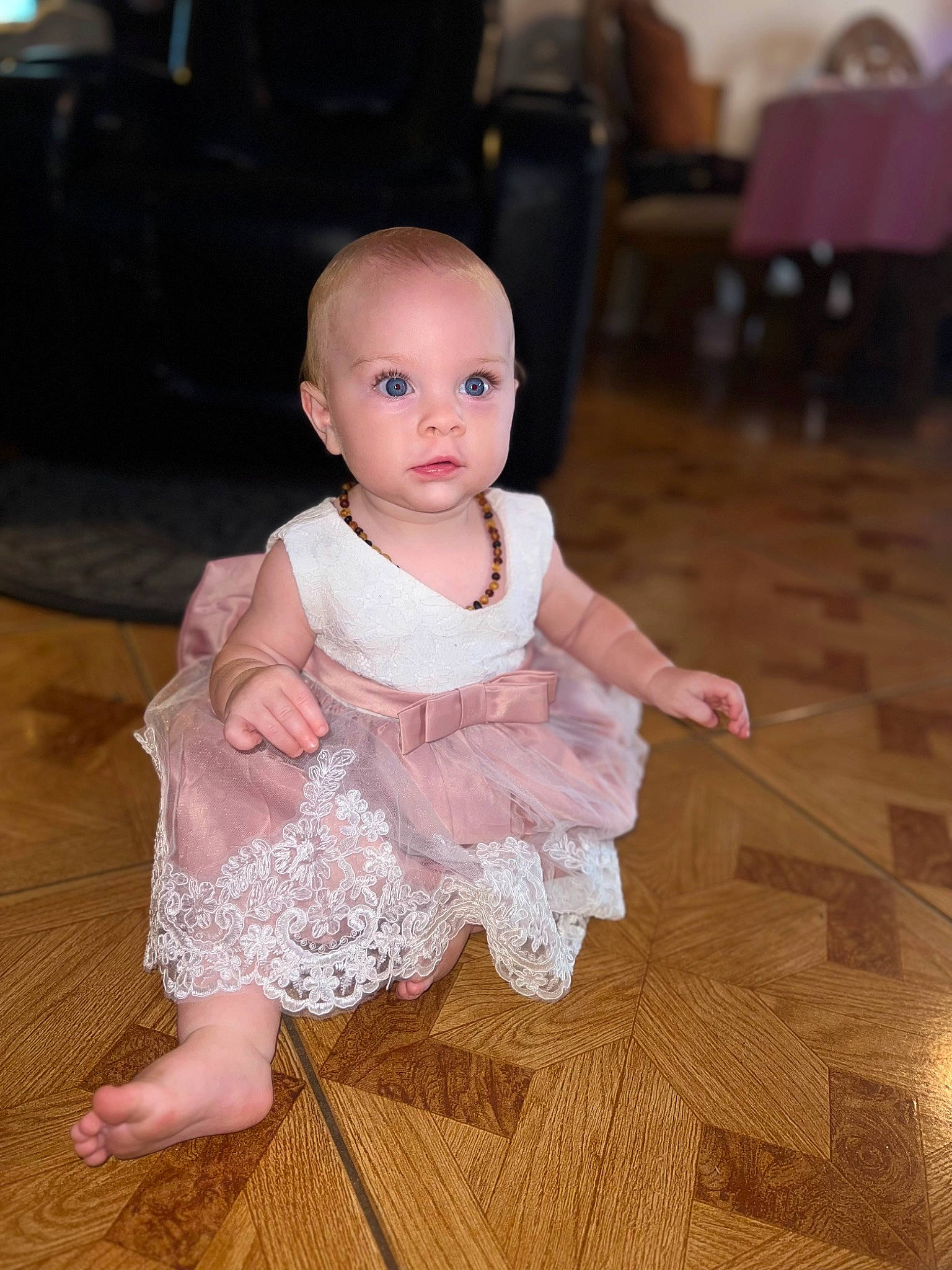 Penelope joined the competition — help win amazing prizes! baby, baby_toddler_clothing, chair, cheek, child, dress, embellishment, event, flash_photography, floor, flooring, fun, happy, hardwood, iris, person, sitting, skin, sleeve, toddler
