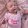 Emerie joined the competition — help win amazing prizes! baby, infant, smiling, pink_clothing, floral_blanket, lying_down, happy, cute, child, portrait, soft_texture, indoors, human, newborn, toddler, cute_expression, small_hand, short_sleeves, head, face