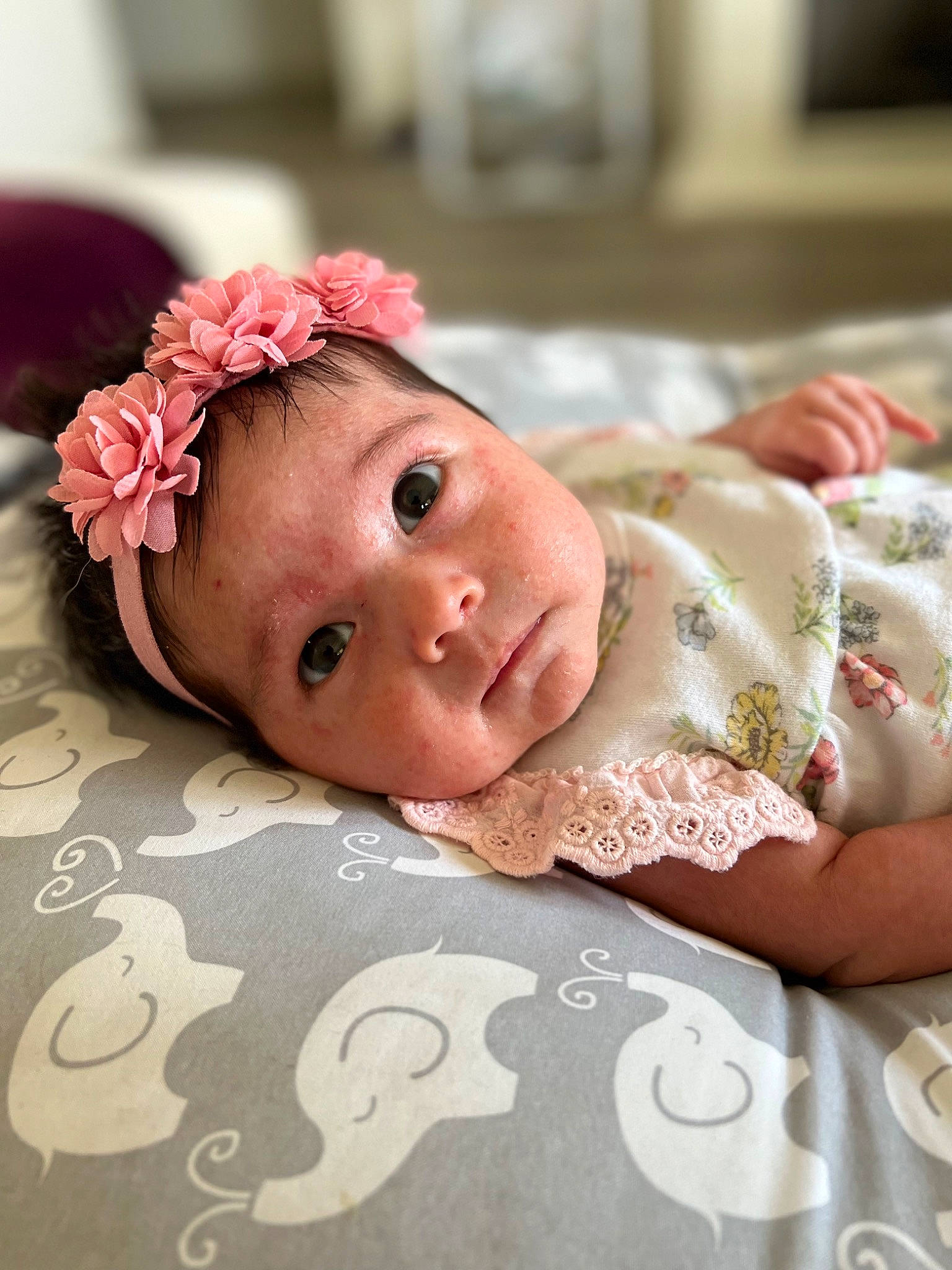 Maggie is registered to the contest to win money with this photo: baby, baby_products, baby_toddler_clothing, cheek, child, chin, comfort, eye, eyelash, flooring, flower, happy, head, headgear, linens, lip, person, pink, skin, textile