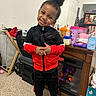 Jaleel is registered to the contest to win money with this photo: carpet, casual, child, clothing, cup, fireplace, floor, hair_puff, happy, home, indoor, mirror, nike, person, reflection, smile, table, toy, tracksuit, white_shoes