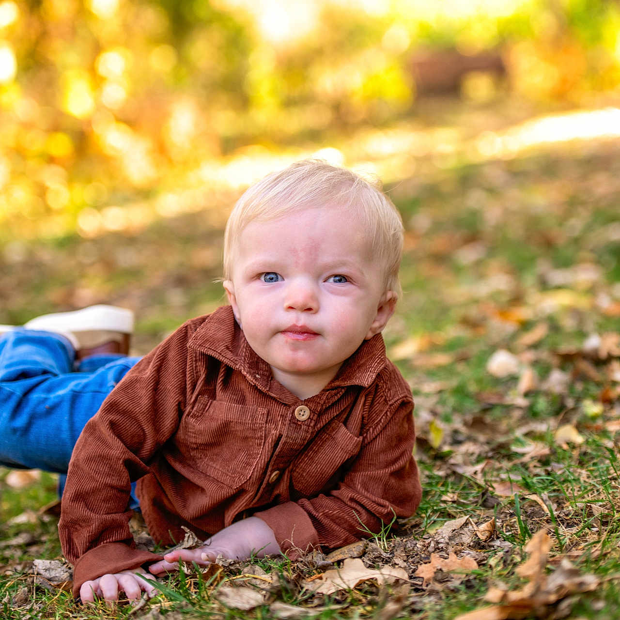 Braxton joined the competition — help win amazing prizes! bodypart, boy, child, clothing, crawling, face, finger, footwear, grass, hand, head, jeans, male, pants, person, photography, plant, portrait, shoe, sitting