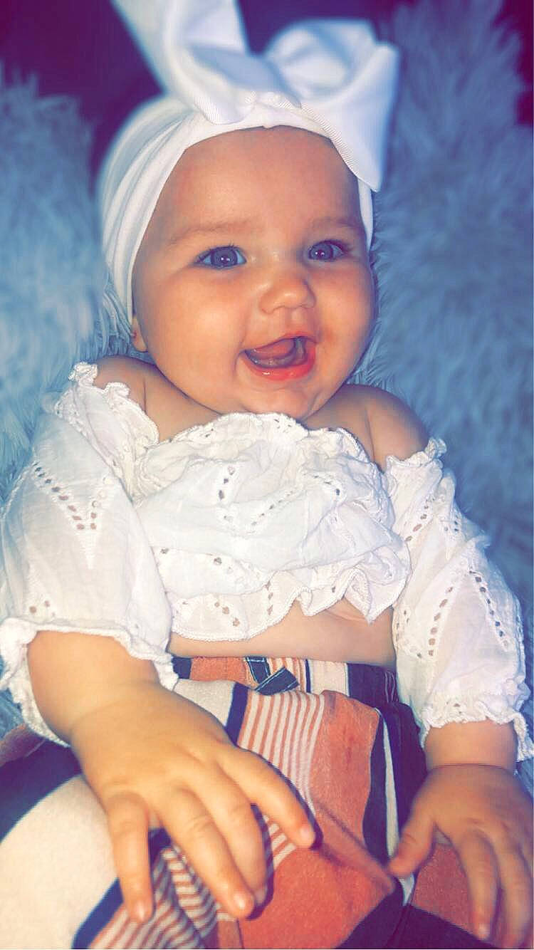 Lyana participe au concours pour gagner de l'argent avec cette photo : azure, baby, baby_toddler_clothing, blue, cap, cheek, eye, facial_expression, gesture, hand, happy, headwear, iris, lip, mouth, organ, person, product, skin, sleeve