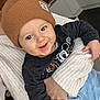 Ewen a rejoint le concours — aidez-le/la à gagner de superbes lots ! baby, child, smiling, blue_eyes, beanie, brown_hat, sweater, person, indoor, kitchen, clothing, cute, happy, holding, infant, casual_wear, portrait, face, hand, light