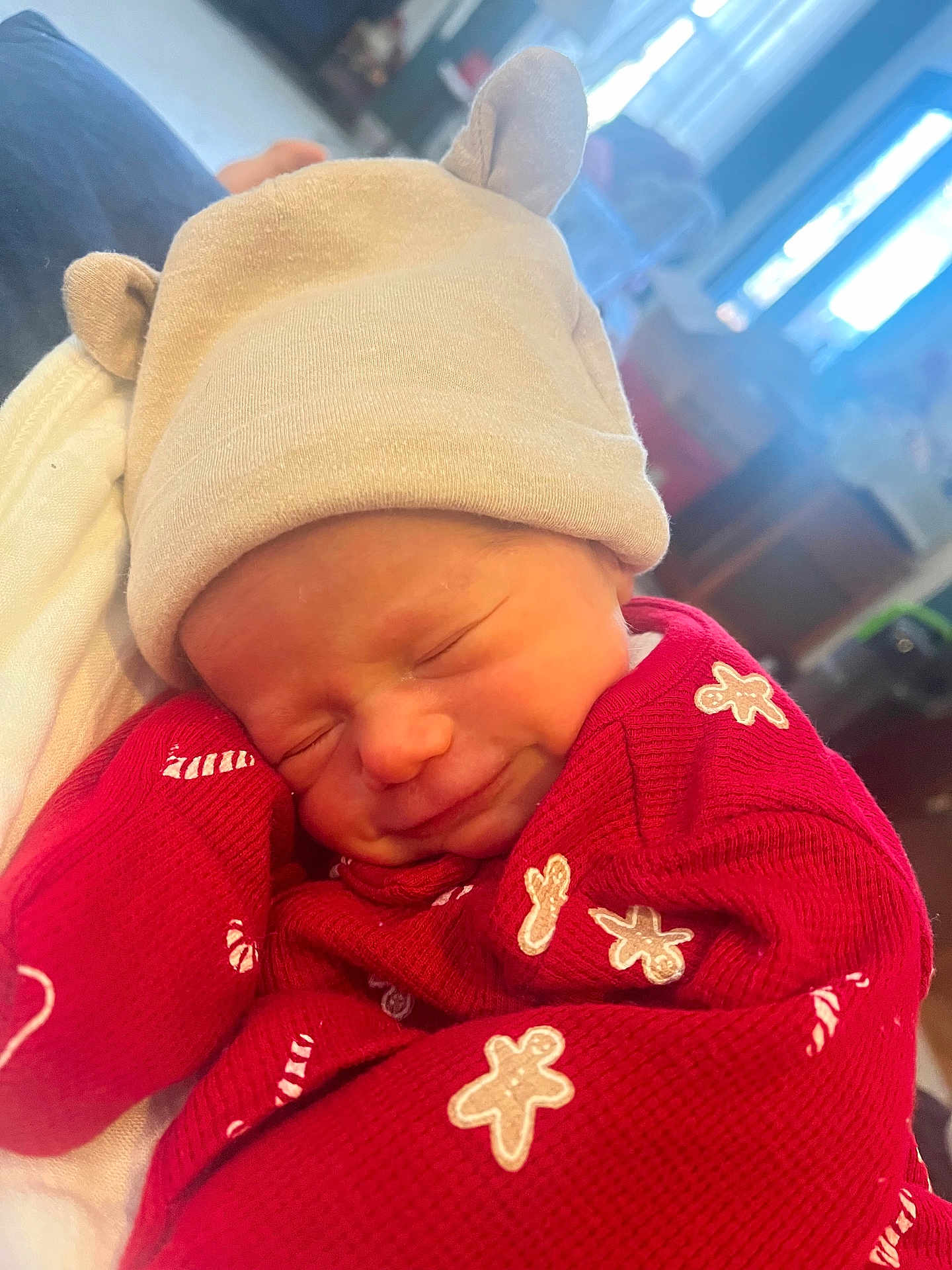 Wesley joined the competition — help win amazing prizes! baby, newborn, hat, beige, red_clothing, gingerbread_men, sleeping, smiling, indoor, cozy, cute, infant, child, soft_light, closeup, portrait, warm, festive, snuggled, person