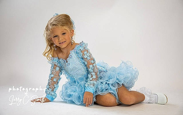 Carleigh is registered to the contest to win money with this photo: baby_toddler_clothing, blond, day_dress, dress, electric_blue, eye, face, fashion_design, flash_photography, hair, happy, head, human_leg, joy, knee, person, sitting, skin, sleeve, smile