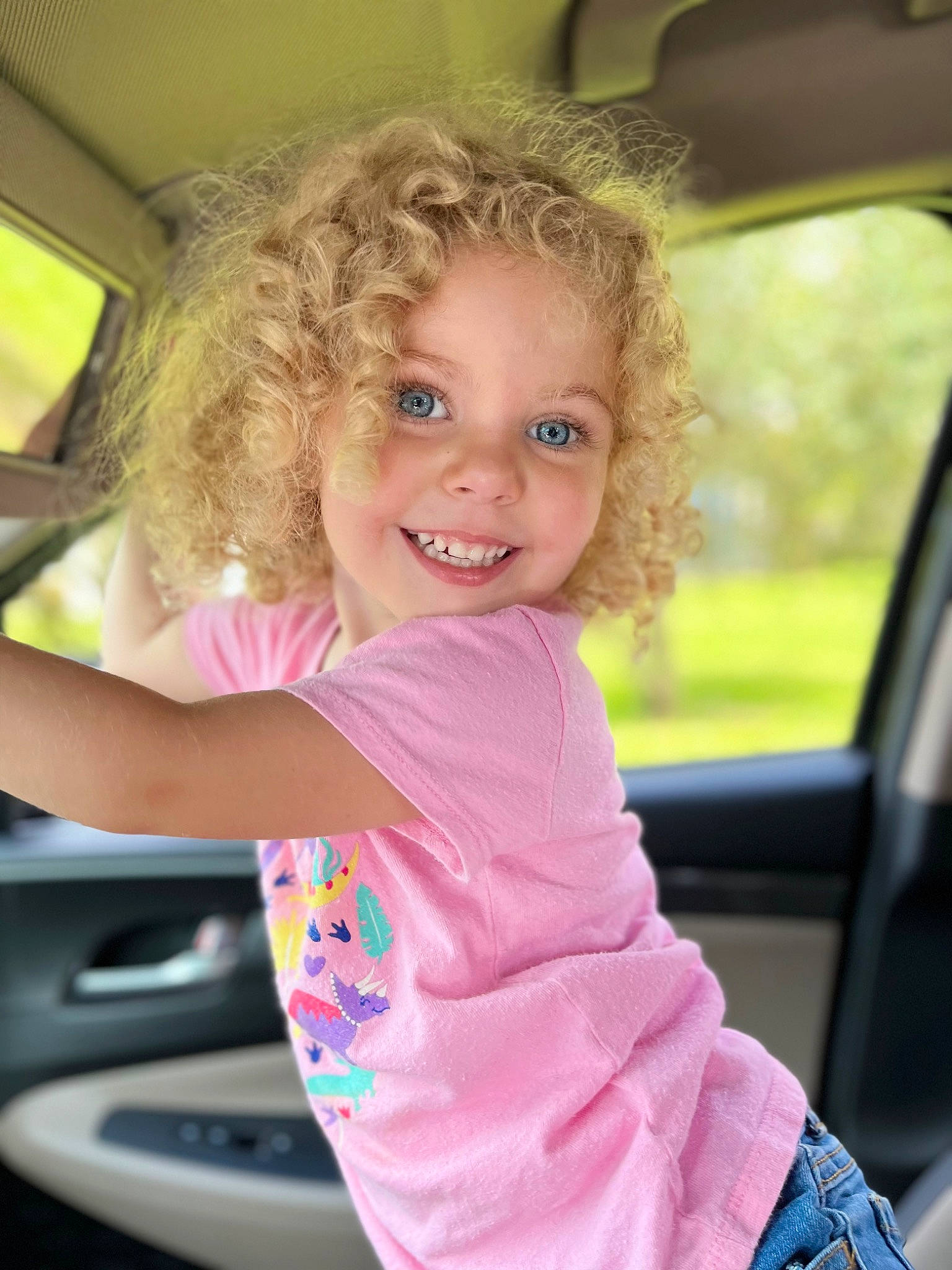 Jazzy is registered to the contest to win money with this photo: auto_part, automotive_design, automotive_exterior, automotive_mirror, bumper, car_seat, chin, cool, fun, grass, hairstyle, happy, joy, leisure, lip, motor_vehicle, person, pink, skin, smile