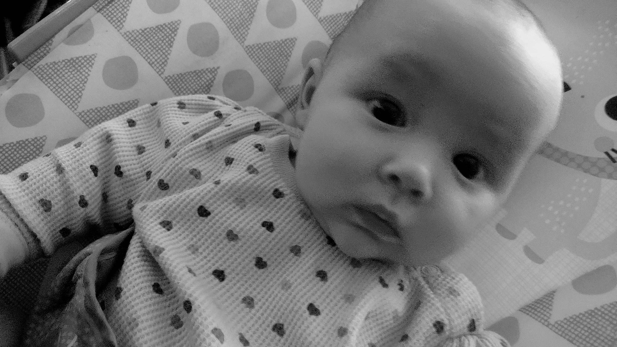 Shyann is registered to the contest to win money with this photo: baby, baby_toddler_clothing, cheek, child, collar, comfort, facial_expression, happy, iris, linens, mammal, monochrome, monochrome_photography, nose, pattern, person, product, skin, textile, toddler