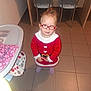 Charleen participe au concours pour gagner de l'argent avec cette photo : toddler, child, glasses, red_sweater, indoor, tile_floor, high_chair, wooden_table, metal_chair, curly_hair, purple_socks, floor, furniture, looking_up, person, young_child, eyes, face, clothing, home
