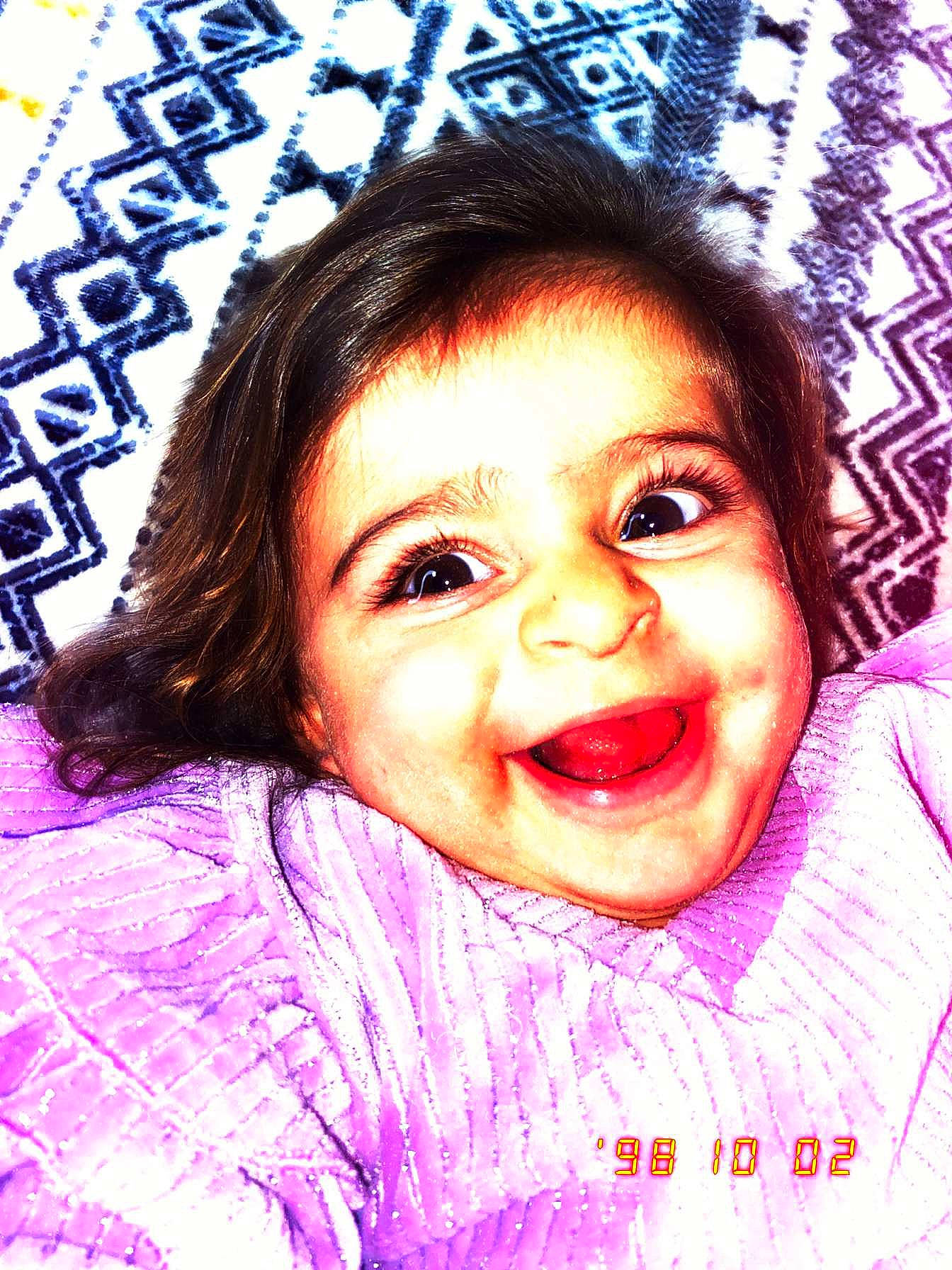 Rachel participe au concours pour gagner de l'argent avec cette photo : baby_toddler_clothing, cheek, eye, eyebrow, eyelash, facial_expression, forehead, happy, iris, joy, laugh, lip, person, photography, pink, pleased, purple, skin, sweater, textile