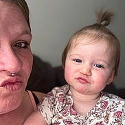 Pais joined the competition — help win amazing prizes! child, baby, adult, woman, selfie, pout, septum_ring, topknot, floral_onesie, patterned_clothing, couch, indoor, closeup, portrait, face, eyes, arm, hand, hair, expression