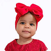 Solana is registered to the contest to win money with this photo: baby, child, girl, red_bow, headband, red_dress, portrait, face, cute, innocent, smile, closeup, studio, fashion, adorable, young_child, expression, curious, background, pretty