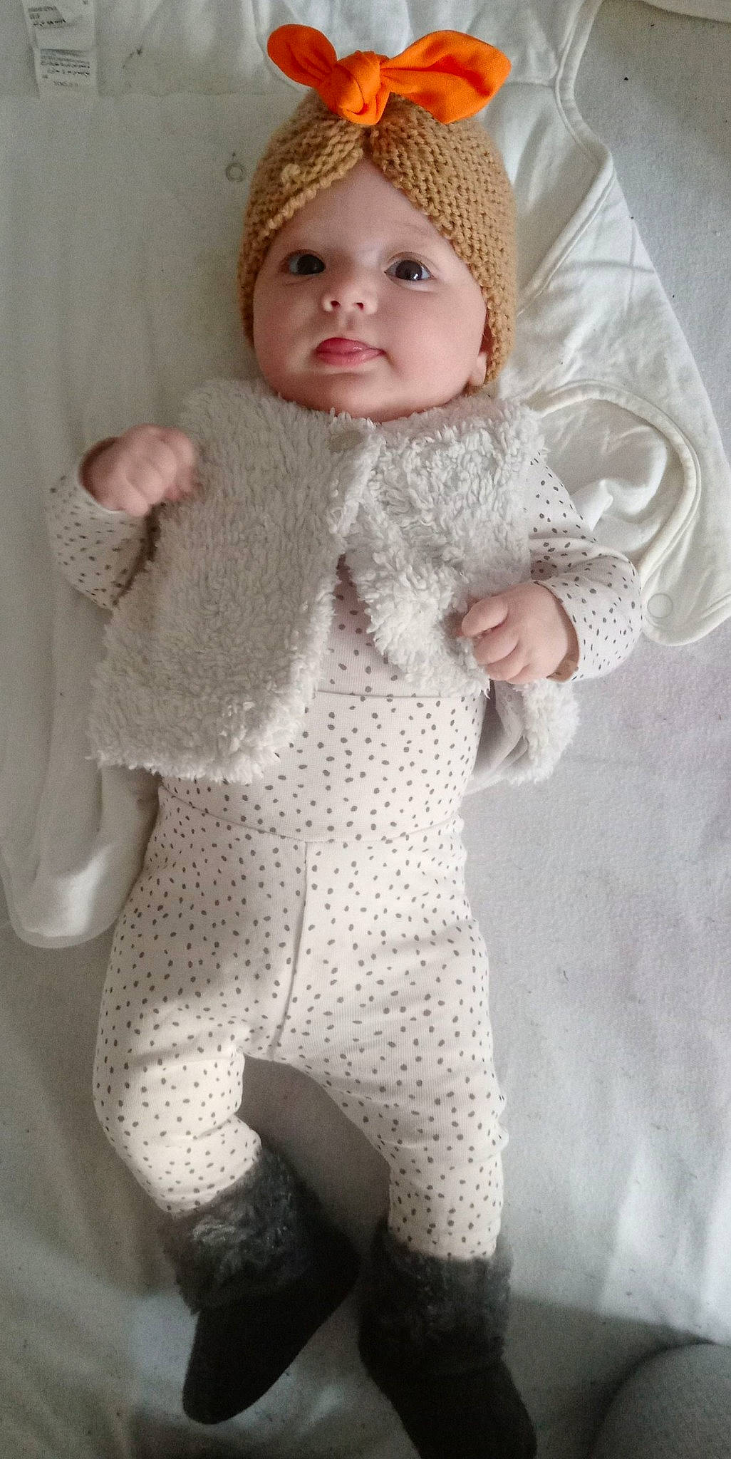 Malyana participe au concours pour gagner de l'argent avec cette photo : arm, baby, baby_toddler_clothing, cap, eye, face, fur, head, headgear, headwear, human_body, iris, lip, neck, pattern, person, skin, sleeve, toddler, white