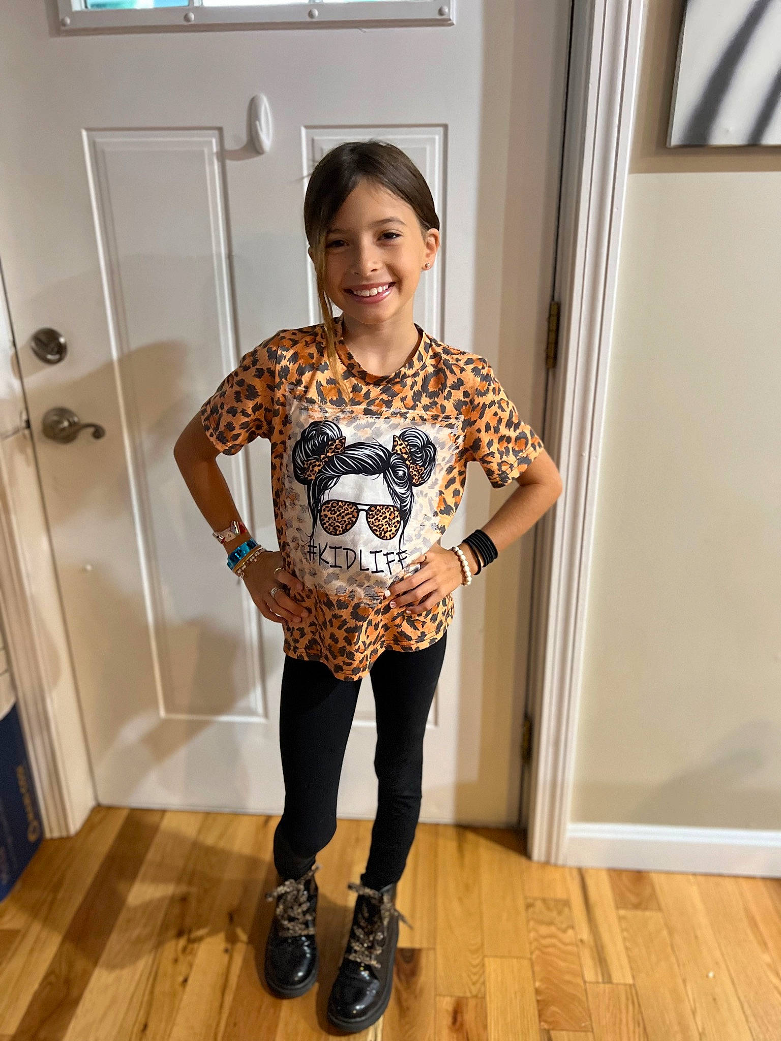 Chanel is registered to the contest to win money with this photo: door, event, fashion_design, flooring, hardwood, human_leg, jewellery, joy, knee, laminate_flooring, leg, neck, pattern, person, shoulder, sleeve, smile, thigh, trunk, waist