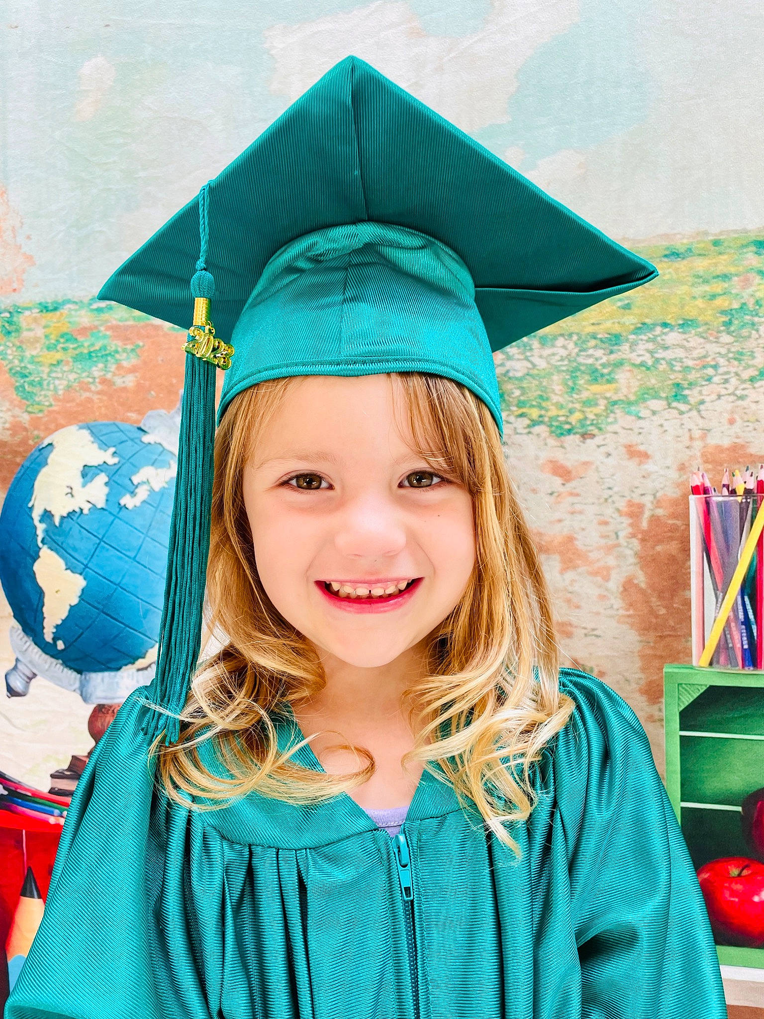 Ava is registered to the contest to win money with this photo: academic_dress, academic_institution, aqua, beauty, child, costume, electric_blue, event, fashion_accessory, fun, graduation, happy, headgear, headwear, joy, mortarboard, people_in_nature, person, scholar, smile