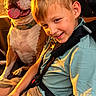 Freja And Athena is registered to the contest to win money with this photo: boy, bulldog, car, car_interior, car_seat, child, dog, golden_hour, happy, looking_at_camera, outdoor_view, pet, portrait, seatbelt, smiling, sunset, tongue_out, travel, vehicle, warm_lighting