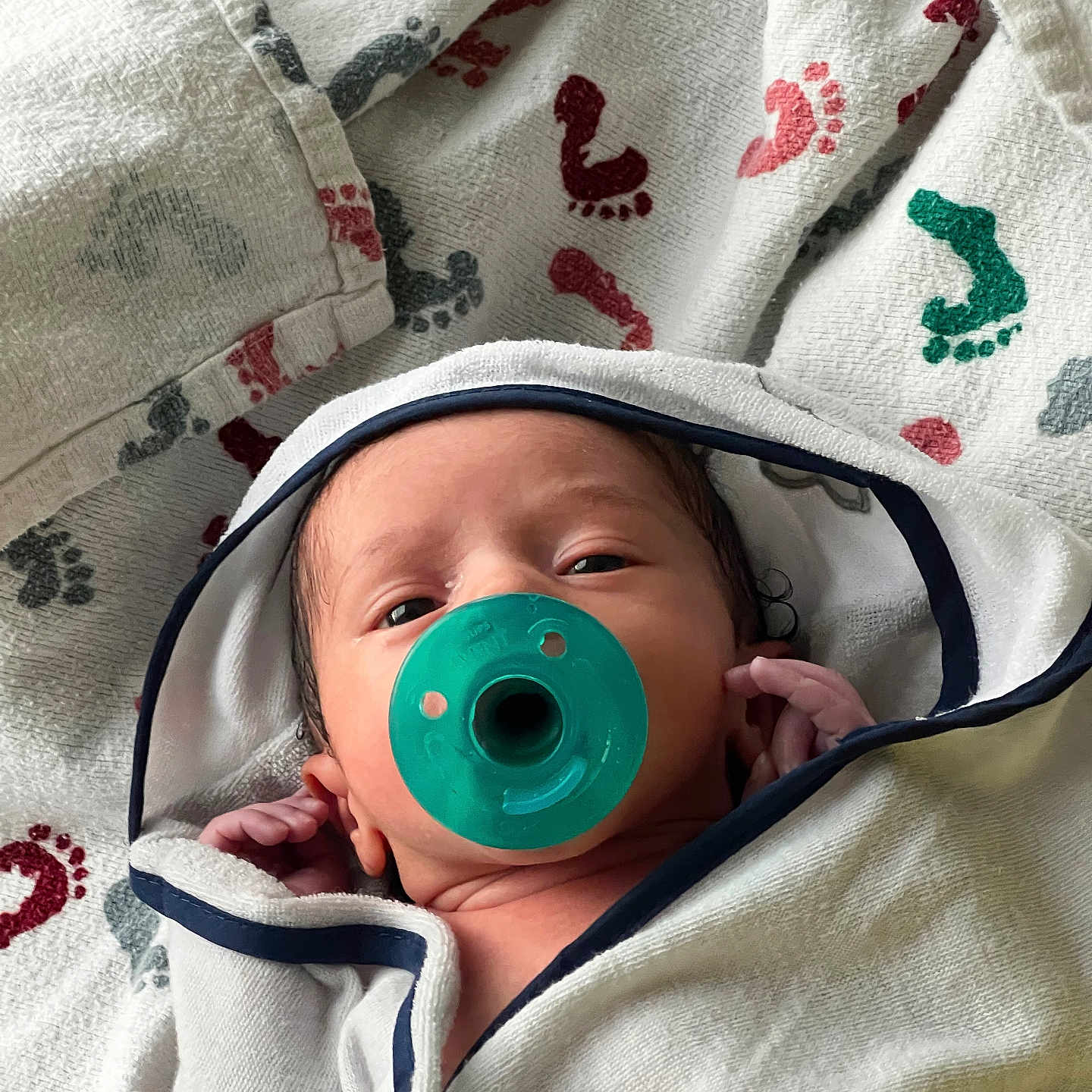 Suede joined the competition — help win amazing prizes! baby, blanket, blue_trim, child, closeup, cute, face, footprint_pattern, green, hand, indoor, infant, newborn, pacifier, portrait, sleepy, soft, towel, white, wrapped