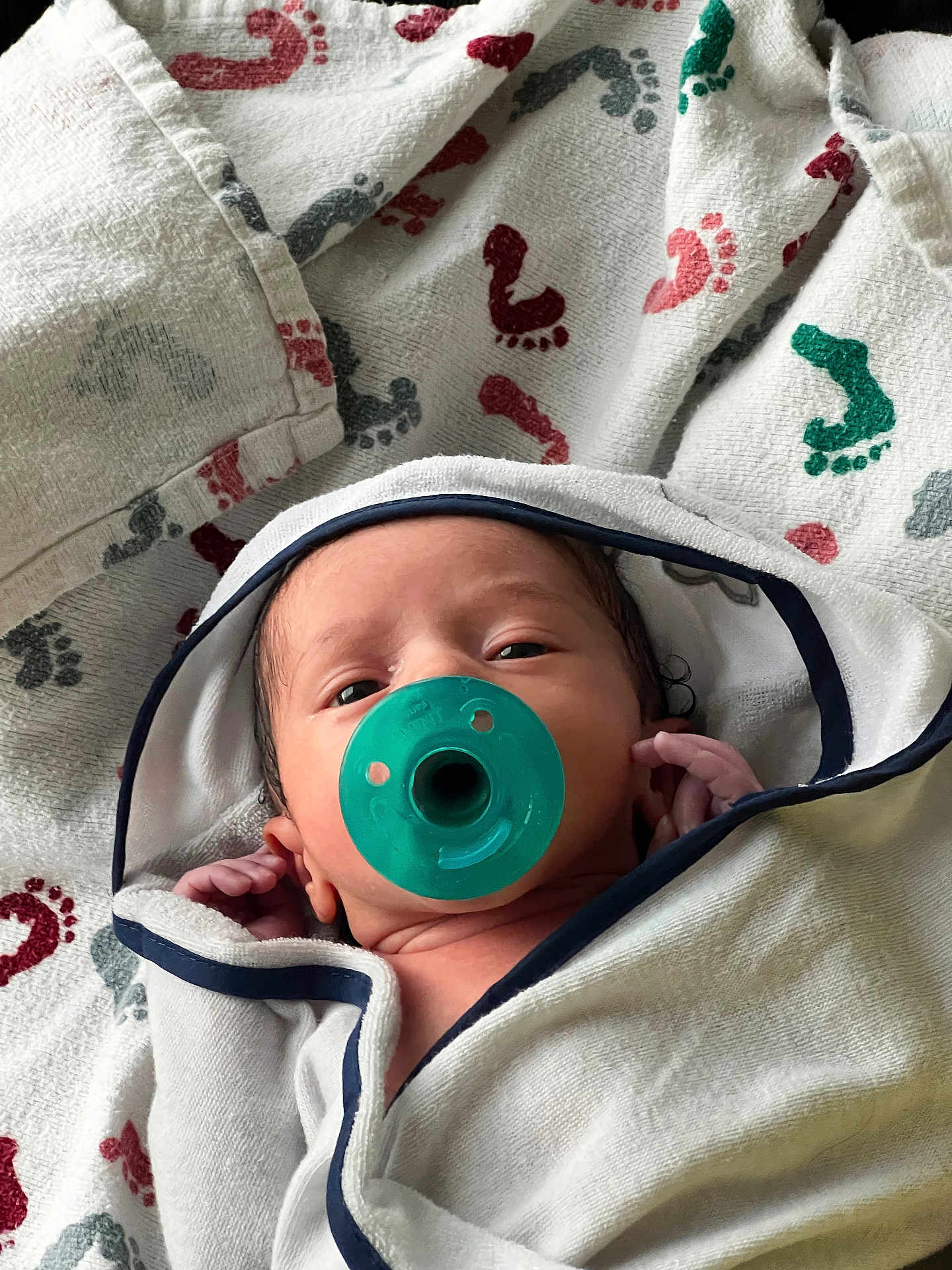 Suede joined the competition — help win amazing prizes! newborn, baby, pacifier, towel, blanket, footprint_pattern, infant, wrapped, cute, face, hand, white, blue_trim, green, closeup, indoor, soft, sleepy, portrait, child