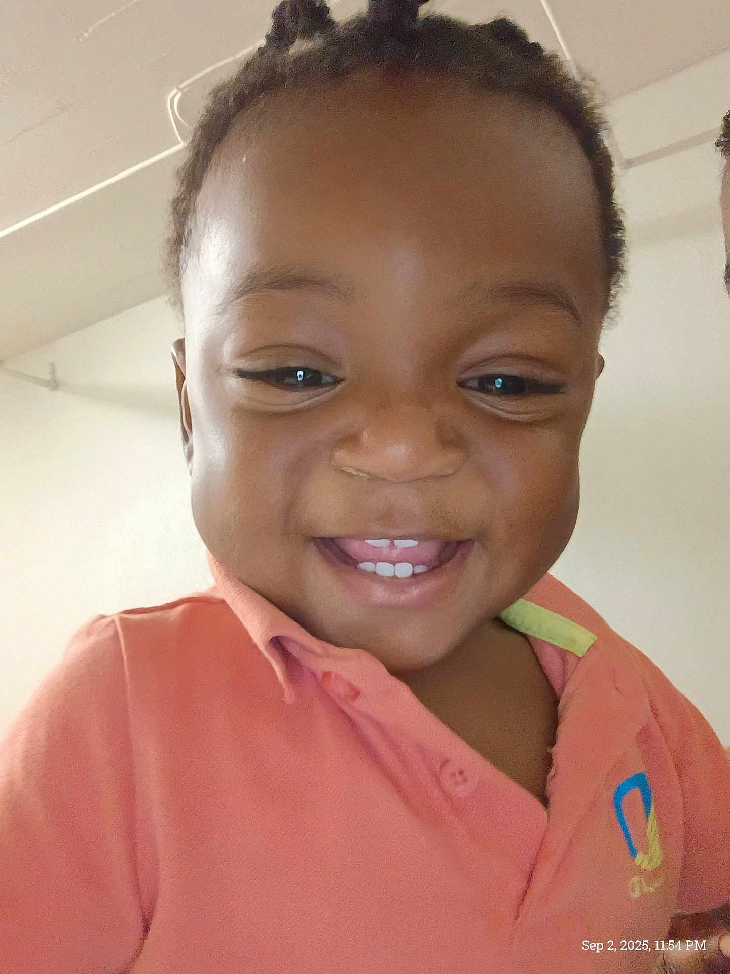 Titan joined the competition — help win amazing prizes! child, smiling, face, indoors, orange_shirt, happy, portrait, young_child, person, casual_clothing, head, cute, teeth, hair, expression, closeup, light, background, ceiling, logo
