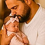 Lou a rejoint le concours — aidez-le/la à gagner de superbes lots ! man, baby, sleeping, beard, headband, bow, pink_clothing, white_shirt, holding, affection, closeup, portrait, indoor, warm_lighting, father, infant, love, tenderness, skin, hands