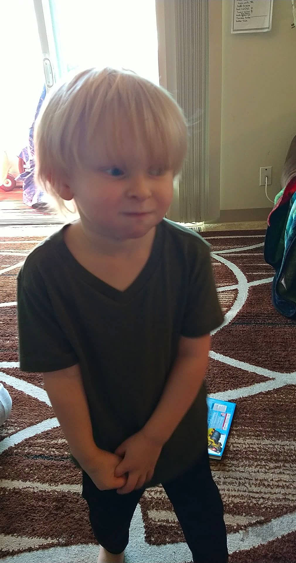 Dakota is registered to the contest to win money with this photo: bangs, blond, child, cool, electric_blue, flooring, fun, grass, hairstyle, happy, head, human_leg, leisure, person, play, shoulder, sitting, t_shirt, toddler, tree