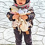 toddler, child, hoodie, scarf, toy, stuffed_animal, blue_eyes, outdoor, pavement, shoes, sneakers, cute, cold_weather, standing, clothing, portrait, holding, playful, happy, casual