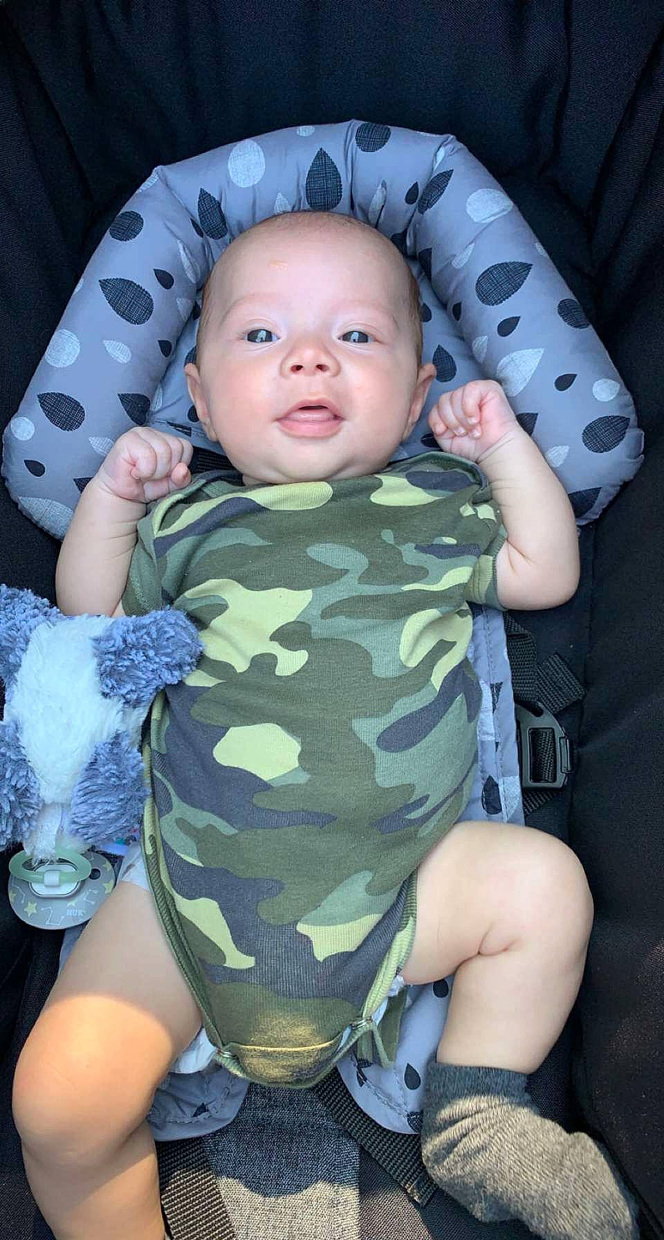 Maddux is registered to the contest to win money with this photo: baby, baby_safety, baby_toddler_clothing, cheek, chin, comfort, cool, eye, face, finger, head, human_body, iris, mouth, neck, nose, organ, person, skin, sleeve