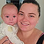 Titan is registered to the contest to win money with this photo: baby, woman, person, smile, face, indoor, holding, clothing, skin, human, portrait, head, eyes, hand, happy, casual, parent, child, family, bedroom