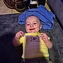 Titan joined the competition — help win amazing prizes! baby, infant, yellow_shirt, chicken_print, smiling, happy, boots, cowboy_boots, sneakers, blue_blanket, carpet, floor_tiles, shadow, indoors, child, person, clothing, head, face, hand