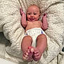 Colton is registered to the contest to win money with this photo: baby, infant, diaper, blanket, smile, feet, tongue, skin, cute, lying_down, happy, child, newborn, human, pale_skin, soft_texture, relaxation, playful, indoors, cozy