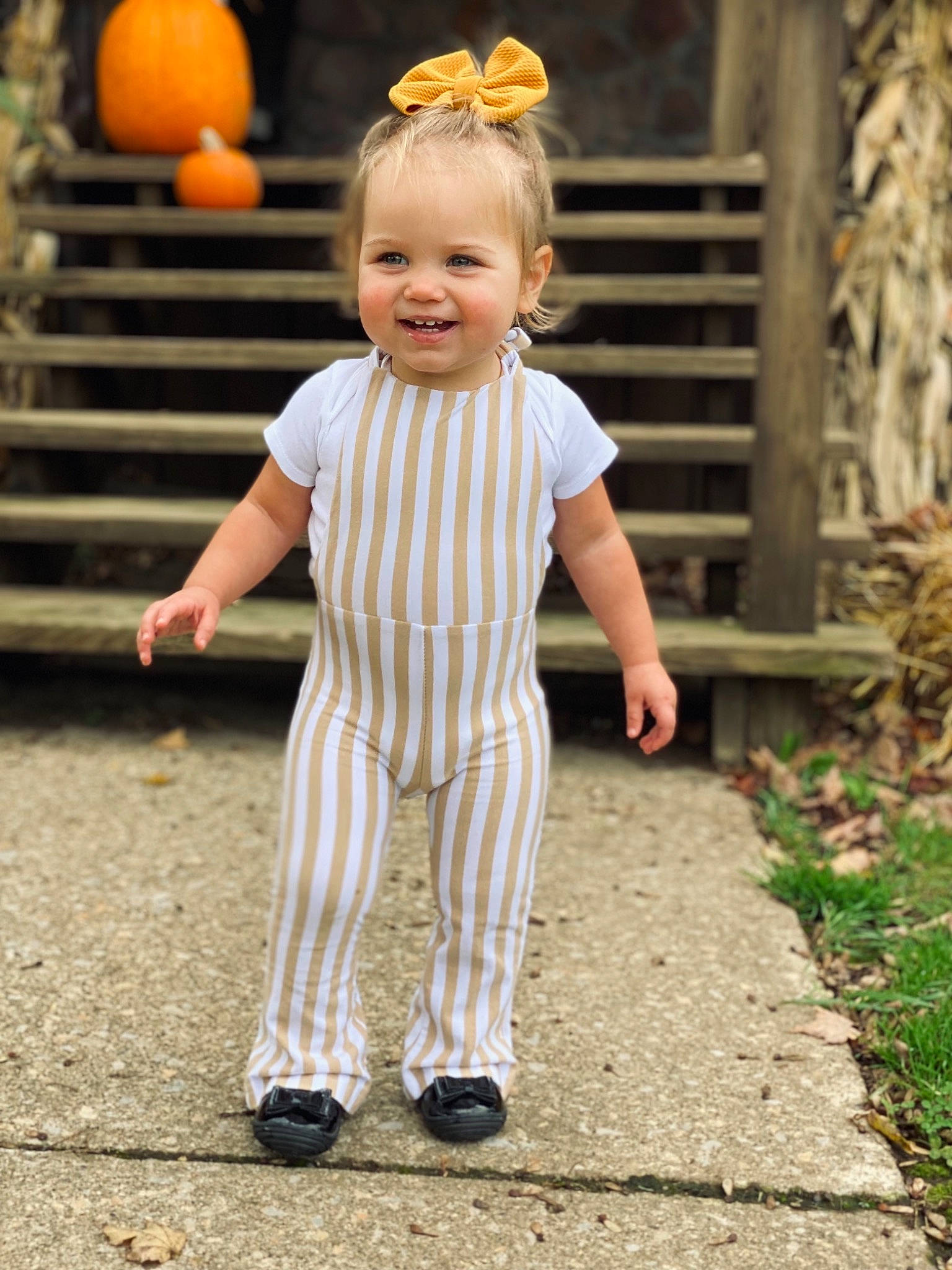 Bexley is registered to the contest to win money with this photo: baby_toddler_clothing, child, eye, face, facial_expression, fun, grass, hairstyle, happy, joy, leisure, natural_foods, people_in_nature, person, plant, pumpkin, sleeve, smile, standing, toddler