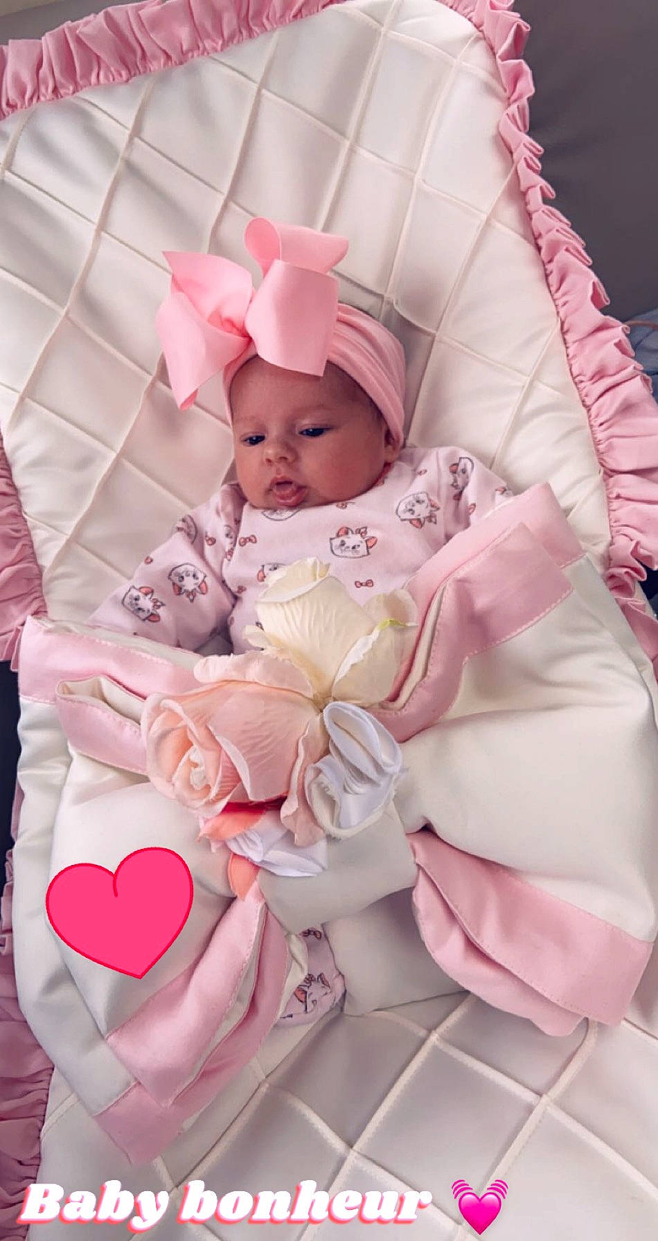 Amber participe au concours pour gagner de l'argent avec cette photo : baby, baby_products, baby_sleeping, baby_toddler_clothing, child, comfort, dress, eye, fashion_accessory, head, headwear, linens, lip, magenta, pattern, peach, person, petal, pink, sleeve