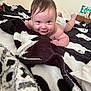 Bradley joined the competition — help win amazing prizes! baby, infant, blanket, tummy, smile, face, indoor, child, diaper, skin, hair, expression, cute, person, cozy, soft, lying_down, looking_up, blue_eyes, room