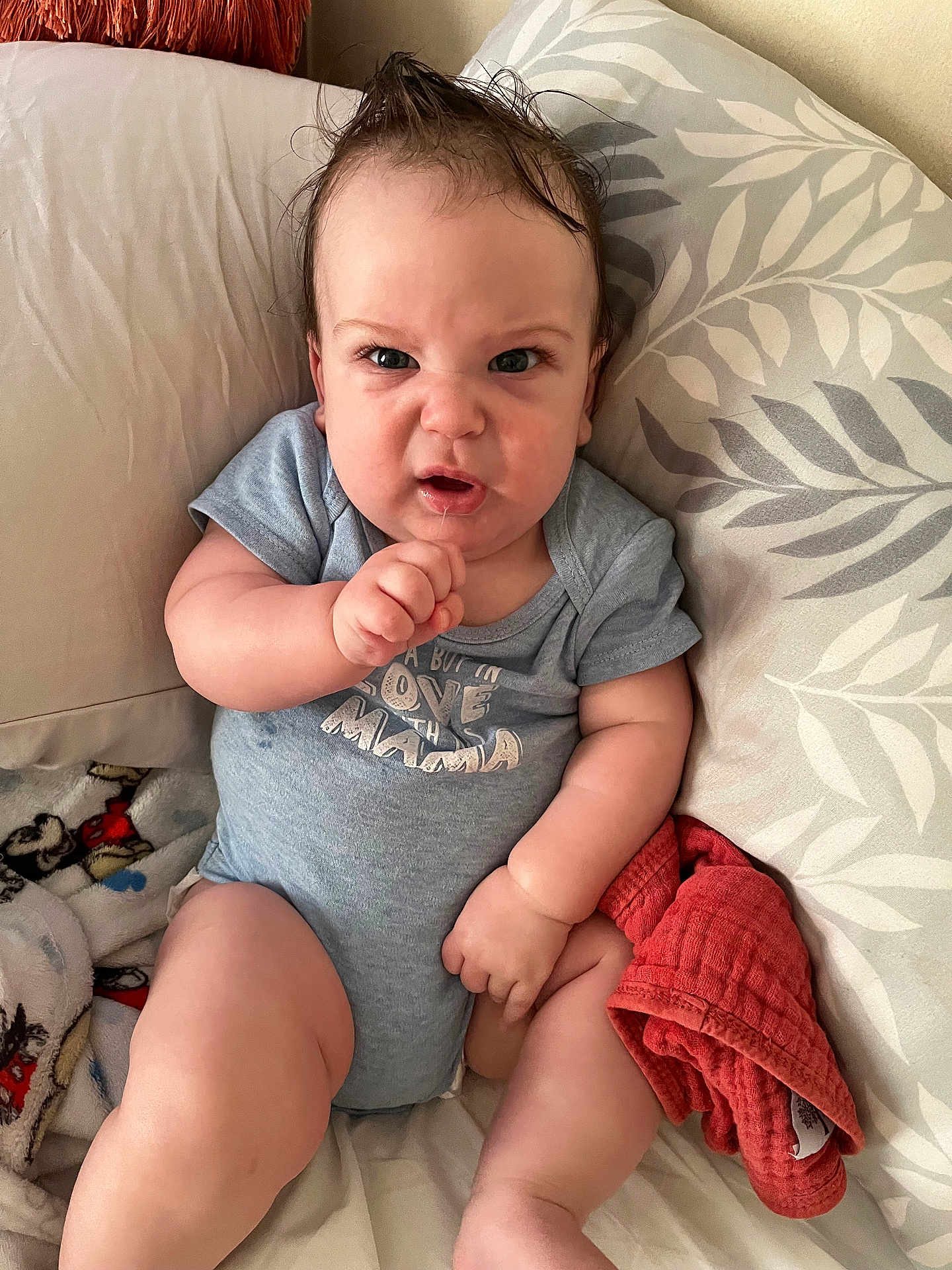 Bradley joined the competition — help win amazing prizes! baby, infant, child, onesie, blue_clothing, couch, pillow, blanket, expression, funny_face, moawk_hair, indoor, person, cute, chubby, skin, hand, sitting, soft_toy, comfortable