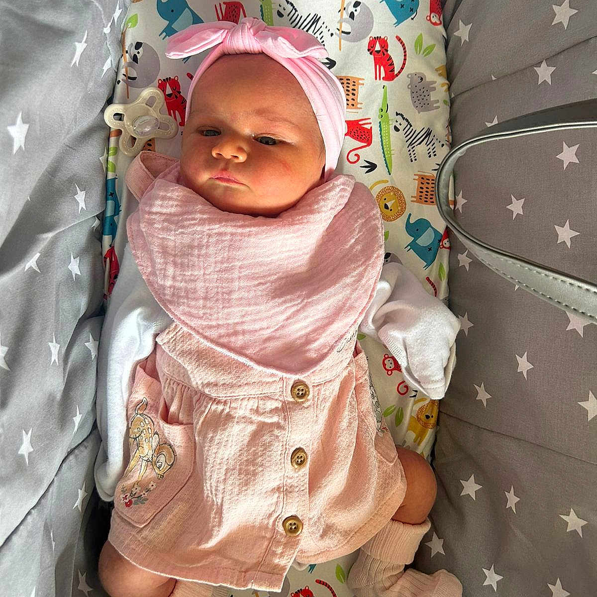 Ava Rose is registered to the contest to win money with this photo: adorable, animal_print, baby, bedding, child, comfortable, cozy, cushion, cute, headband, indoor, infant, lying_down, newborn, pacifier, pink_clothing, portrait, socks, soft_lighting, star_pattern