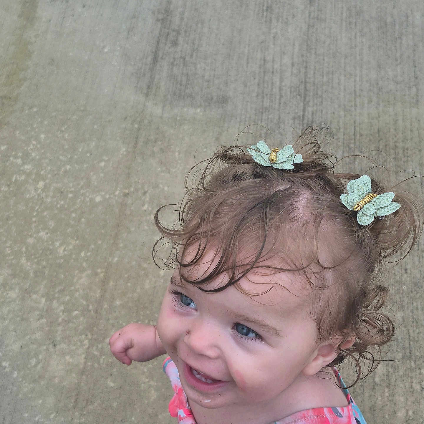 Nyx joined the competition — help win amazing prizes! toddler, child, smiling, curly_hair, hair_clips, butterfly_clips, colorful_clothing, outdoor, concrete, portrait, happy, cute, young_child, face, blue_eyes, playful, summer, casual, person, photography
