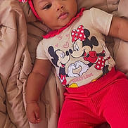 Mariah joined the competition — help win amazing prizes! baby, child, infant, red_bow, headband, mickey_mouse, minnie_mouse, tshirt, red_pants, blanket, bed, cute, portrait, smiling, relaxed, indoors, person, clothing, baby_girl, lying_down