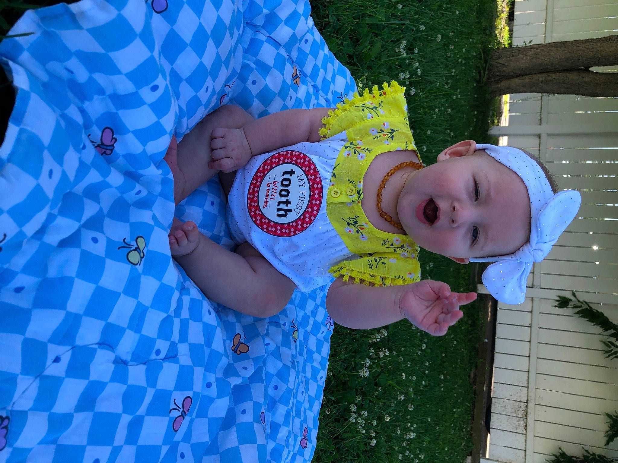 Dixie is registered to the contest to win money with this photo: baby, baby_toddler_clothing, child, electric_blue, event, finger, fun, grass, happy, hat, headwear, leisure, nail, pattern, people_in_nature, person, smile, t_shirt, toddler, tree