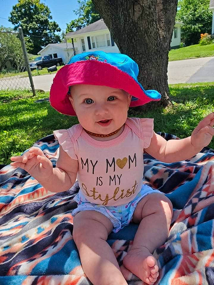 Dixie is registered to the contest to win money with this photo: baby_toddler_clothing, baseball_cap, blue, cap, child, fun, grass, green, happy, hat, headwear, leisure, person, pink, plant, recreation, shorts, summer, sun_hat, t_shirt