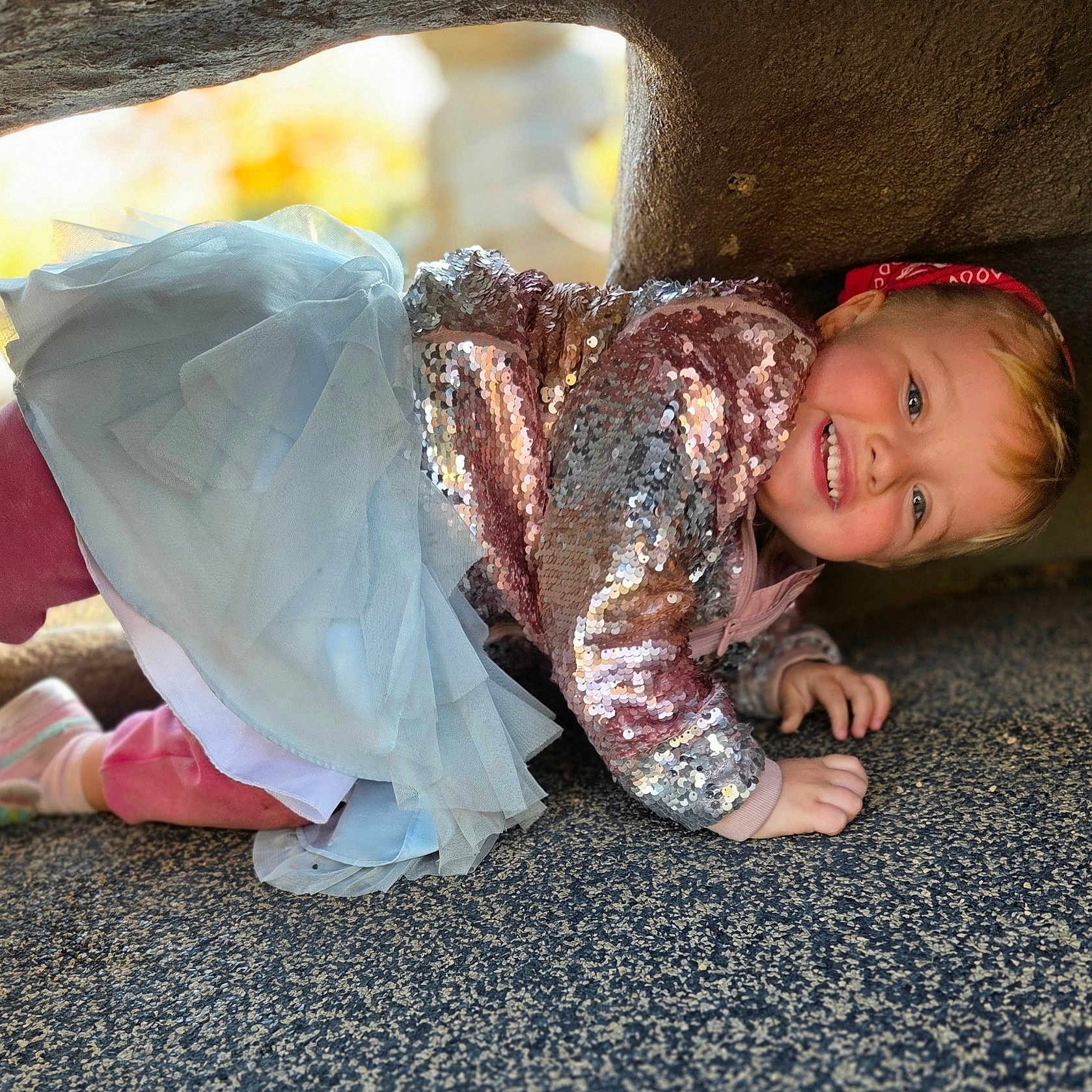 Rolly joined the competition — help win amazing prizes! child, girl, toddler, smiling, happy, crawling, portrait, outdoor, rock, cave, sequin_jacket, blue_skirt, tulle, pink_clothing, headband, blonde_hair, playful, carpet, natural_light, closeup