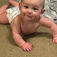 John is registered to the contest to win money with this photo: baby, diaper, crawling, carpet, smile, child, infant, skin, cheeks, eyes, hand, floor, blanket, toy, cute, young, indoors, person, happy, playtime