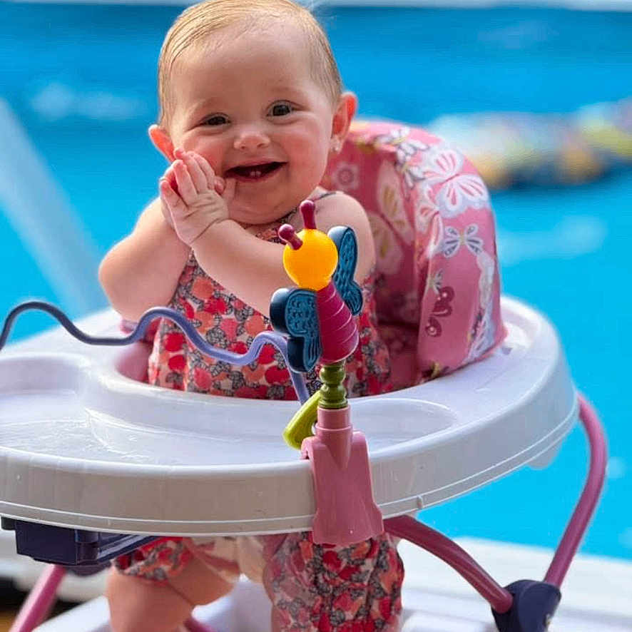 Sunnie Jae joined the competition — help win amazing prizes! baby, blue, child, clothing, cute, fun, happy, infant, outdoor, person, pink, playtime, pool, seat, smiling, summer, sunlight, toy, walker, water